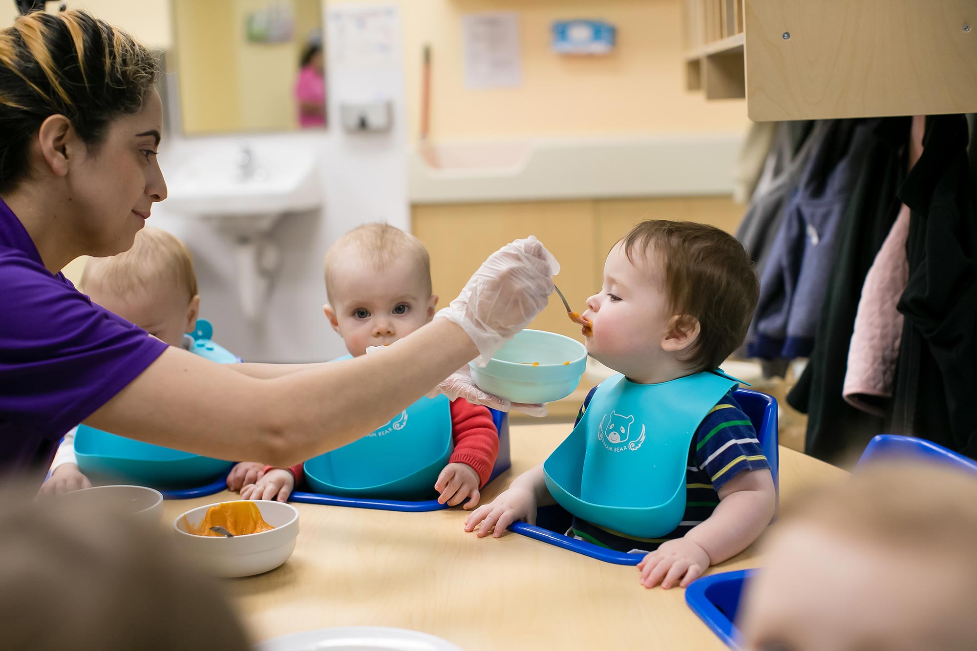 Infants enjoy freshly prepared purees made from organic fruits and vegetables.